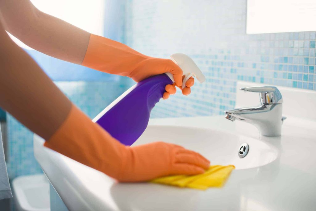 woman doing chores cleaning bathroom at home PNYLL
